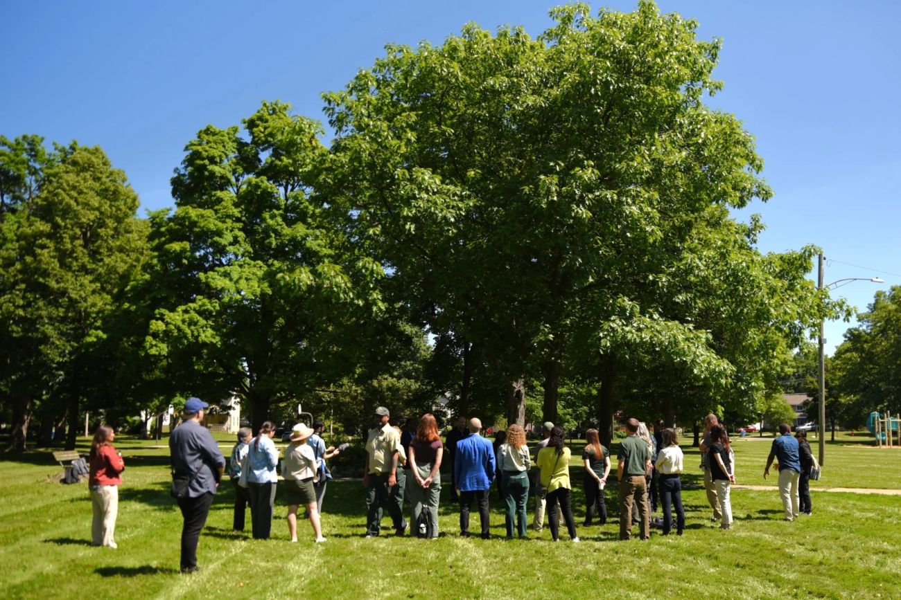 Michigan State University forestry students standing outside next to a tree