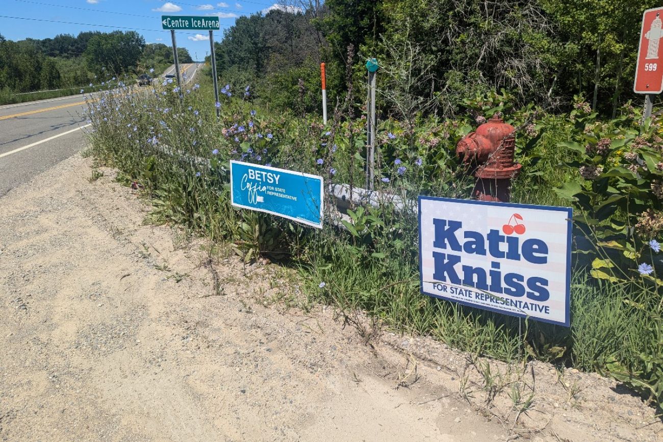 Two signs by the side of the road