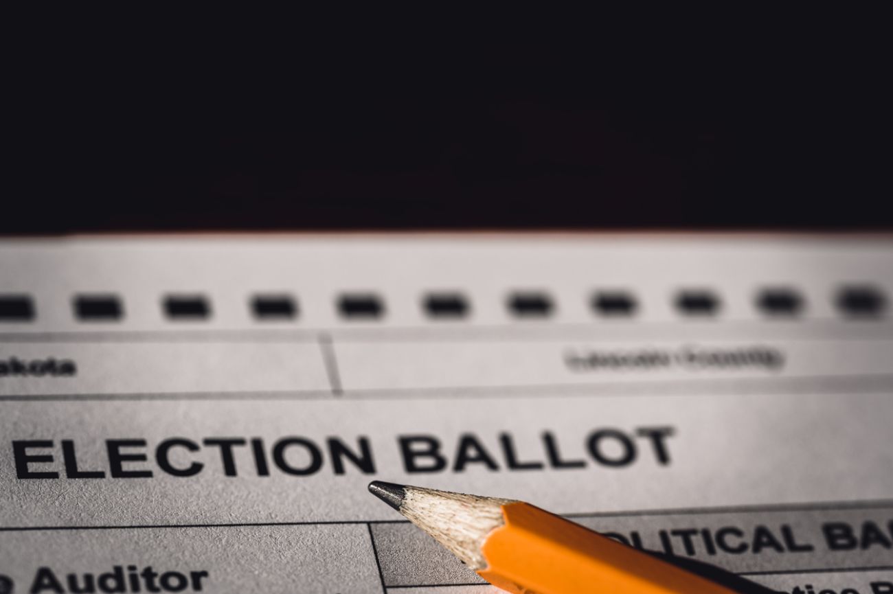  Selective focus on a generic election ballot with a pencil on top. 