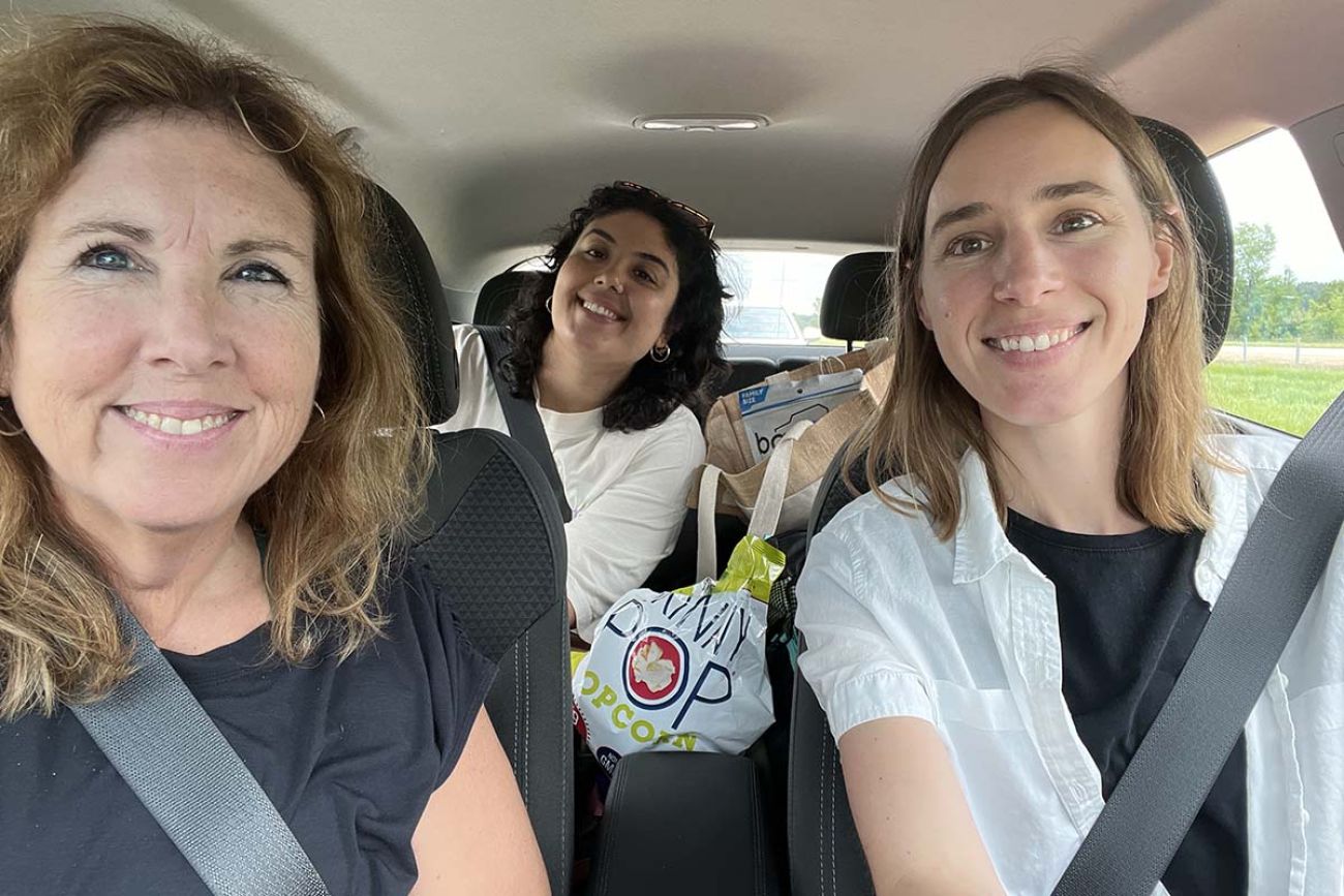 Paula Gardner, Kelly House and Asha Lewis take a selfie inside an EV car