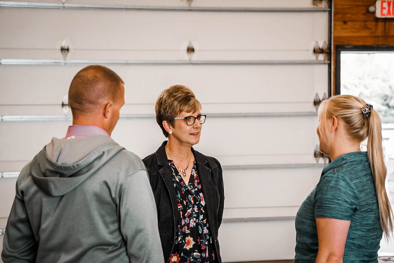 Mary Draves speaking to two reporters