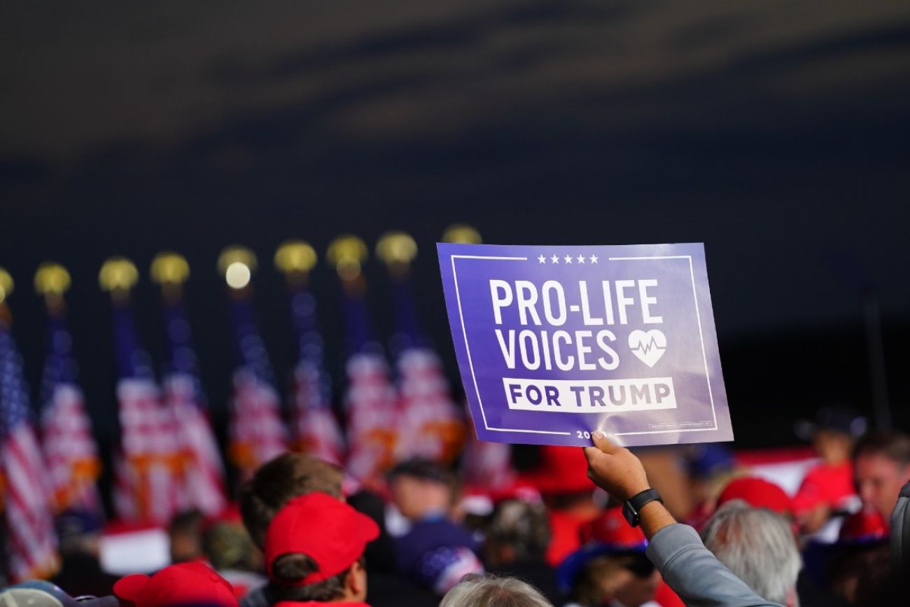 Someone holding sign for Pro-Life Voices for Trump