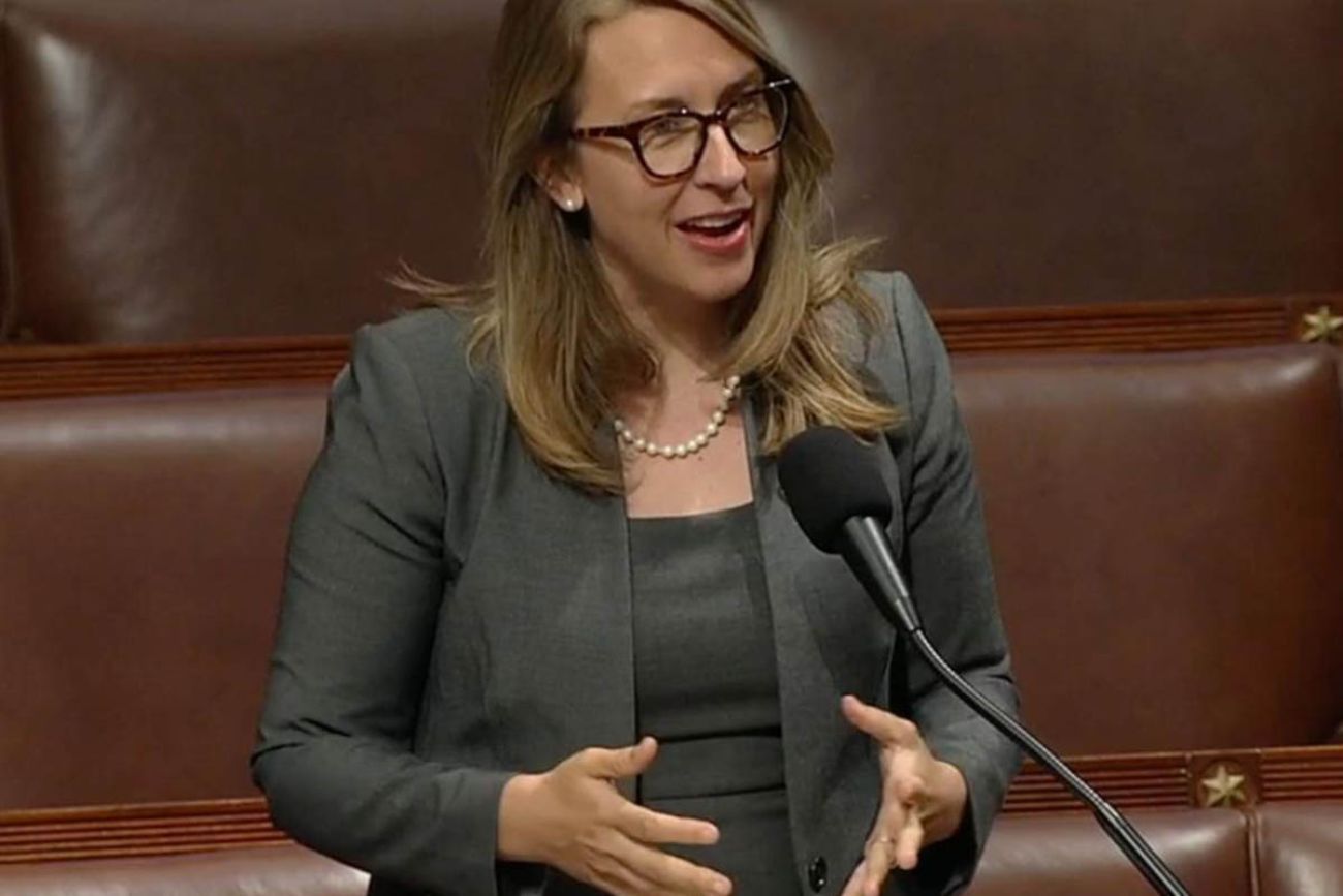 U.S. Rep. Hillary Scholten speaks into a microphone 