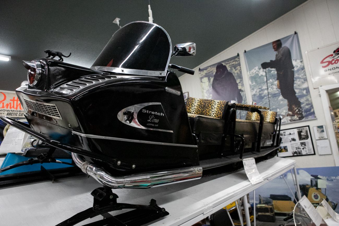 A black snowmobile that looks like a limo 