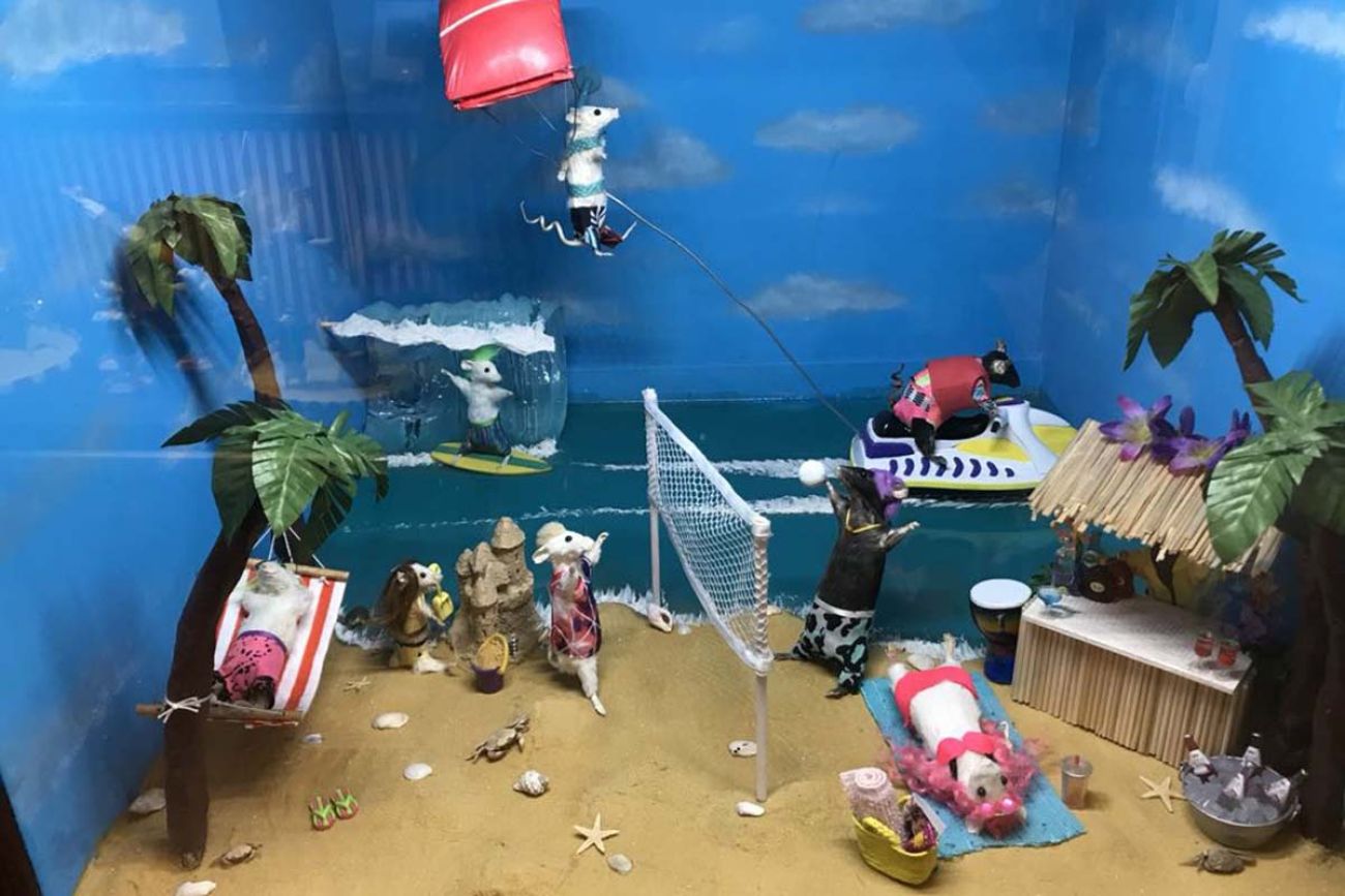 A bunch of taxidermied mice posed as a beach scene 