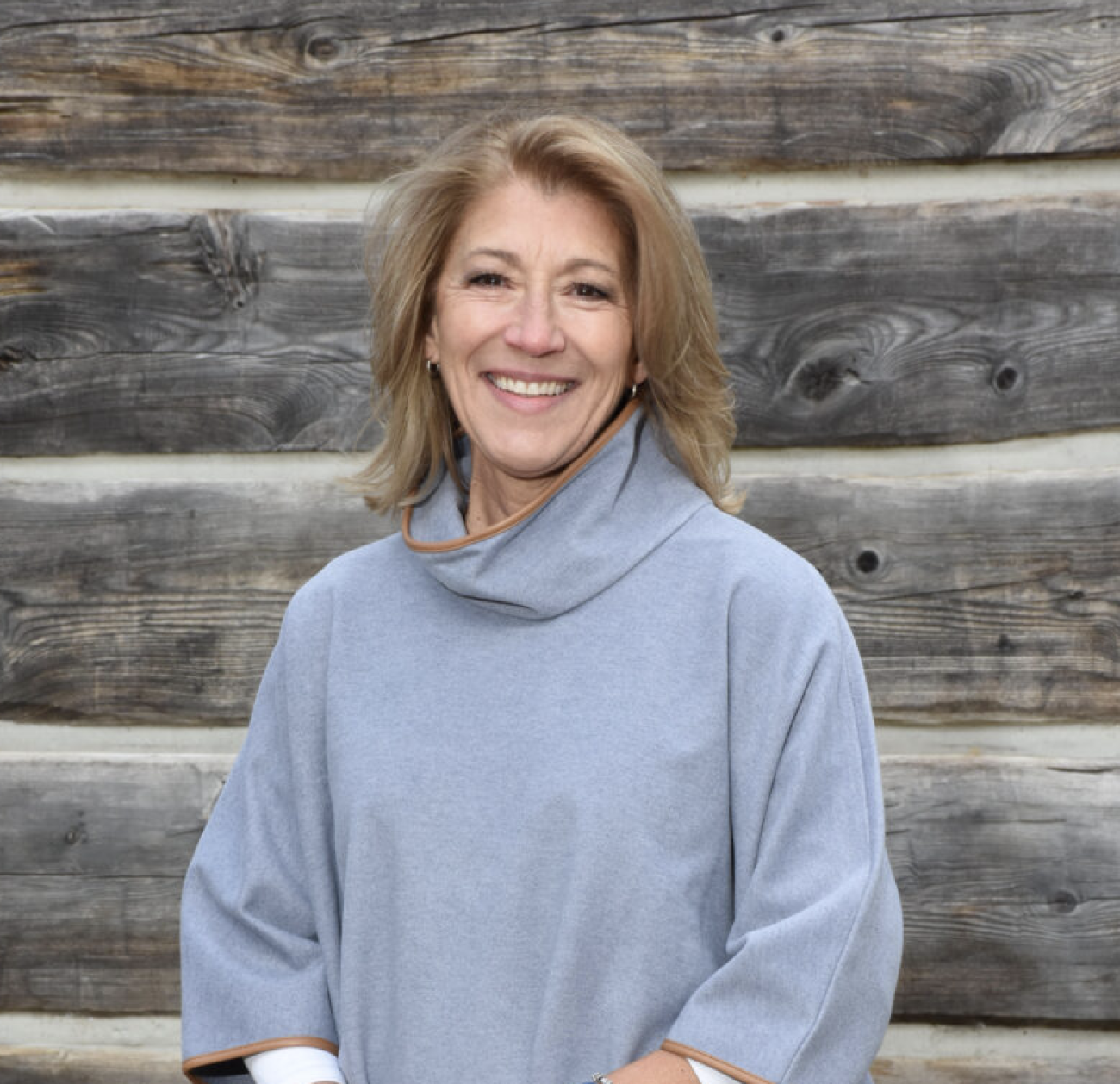 Lisa Trombley, wearing a grey turtleneck, poses for a photo