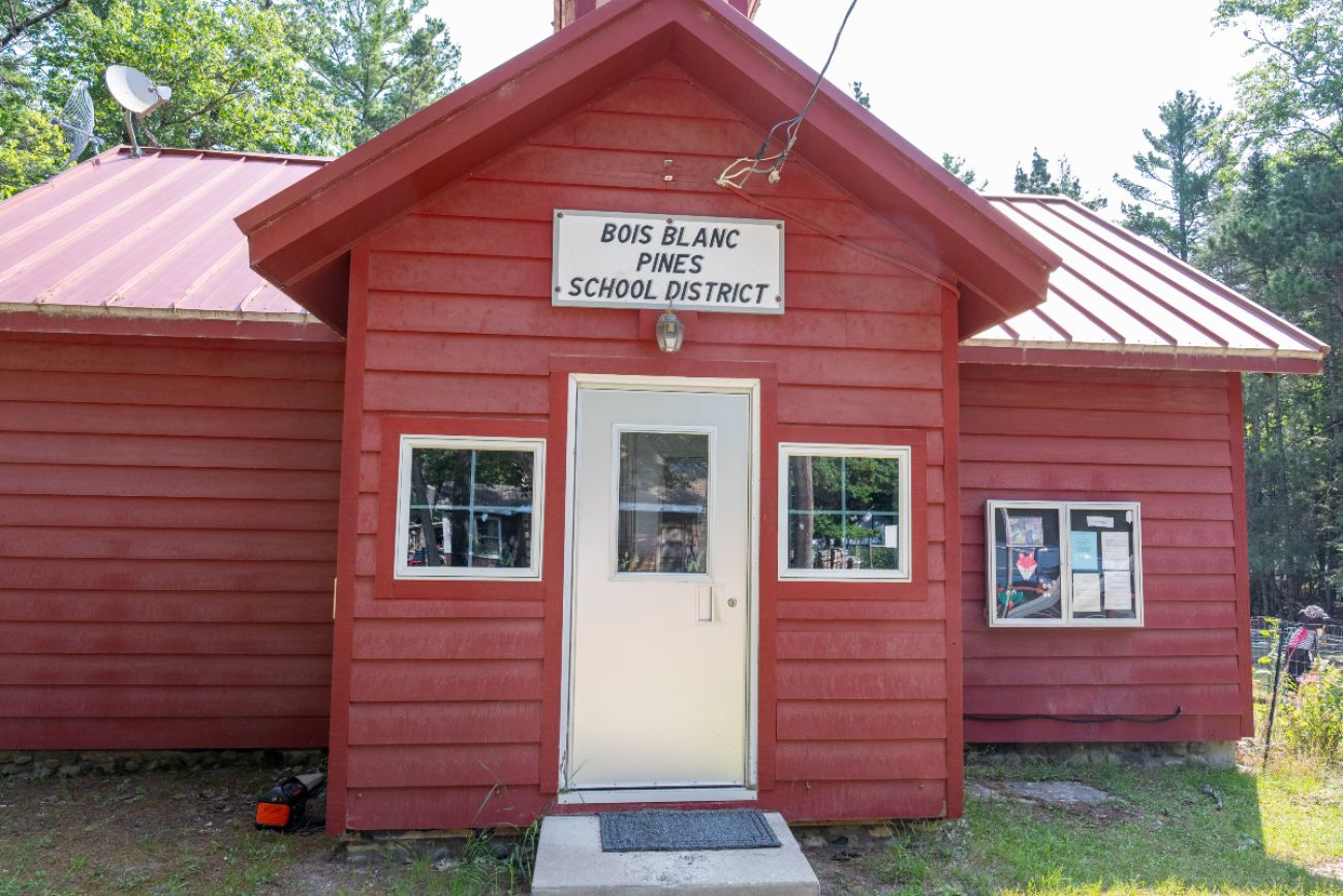 The entrance to the Bois Blanc Pines School, a small red building