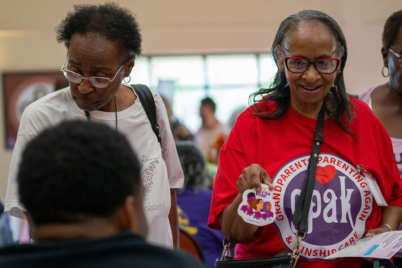 Gwendolyn Swain at a table at the Healthy Black Elders event in Detroit. She is wearing a red shirt