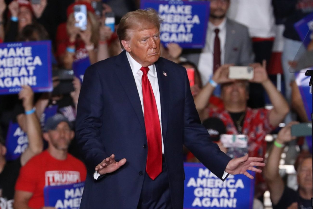 Donald Trump stands on stage at a rally