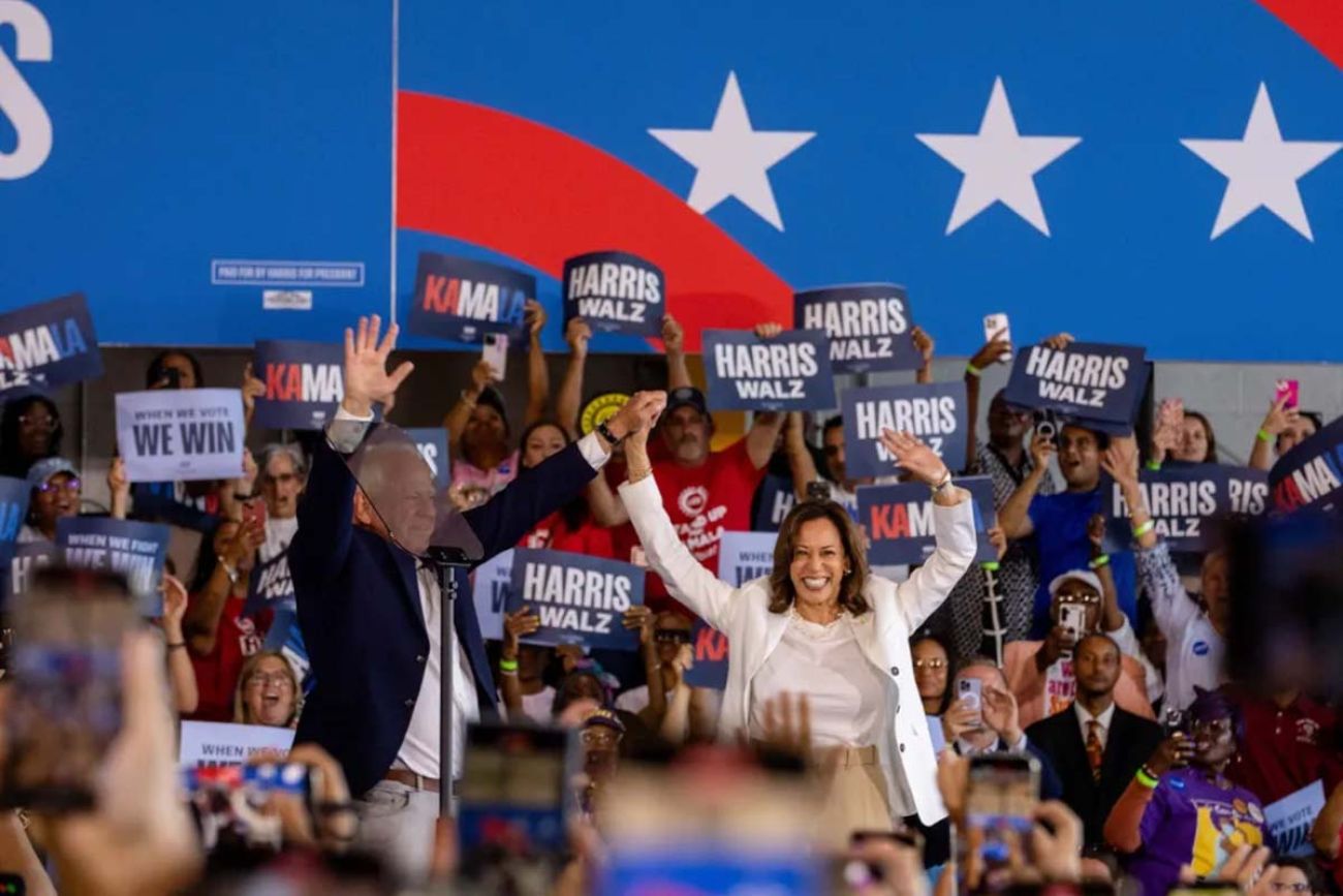 Vice President Kamala Harris and her running mate Tim Walz on a stage at a rally in Michigan