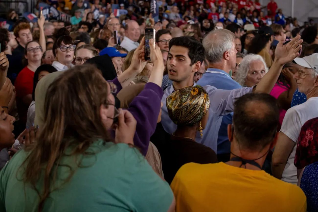 Protesters in a crowd of people in a rally