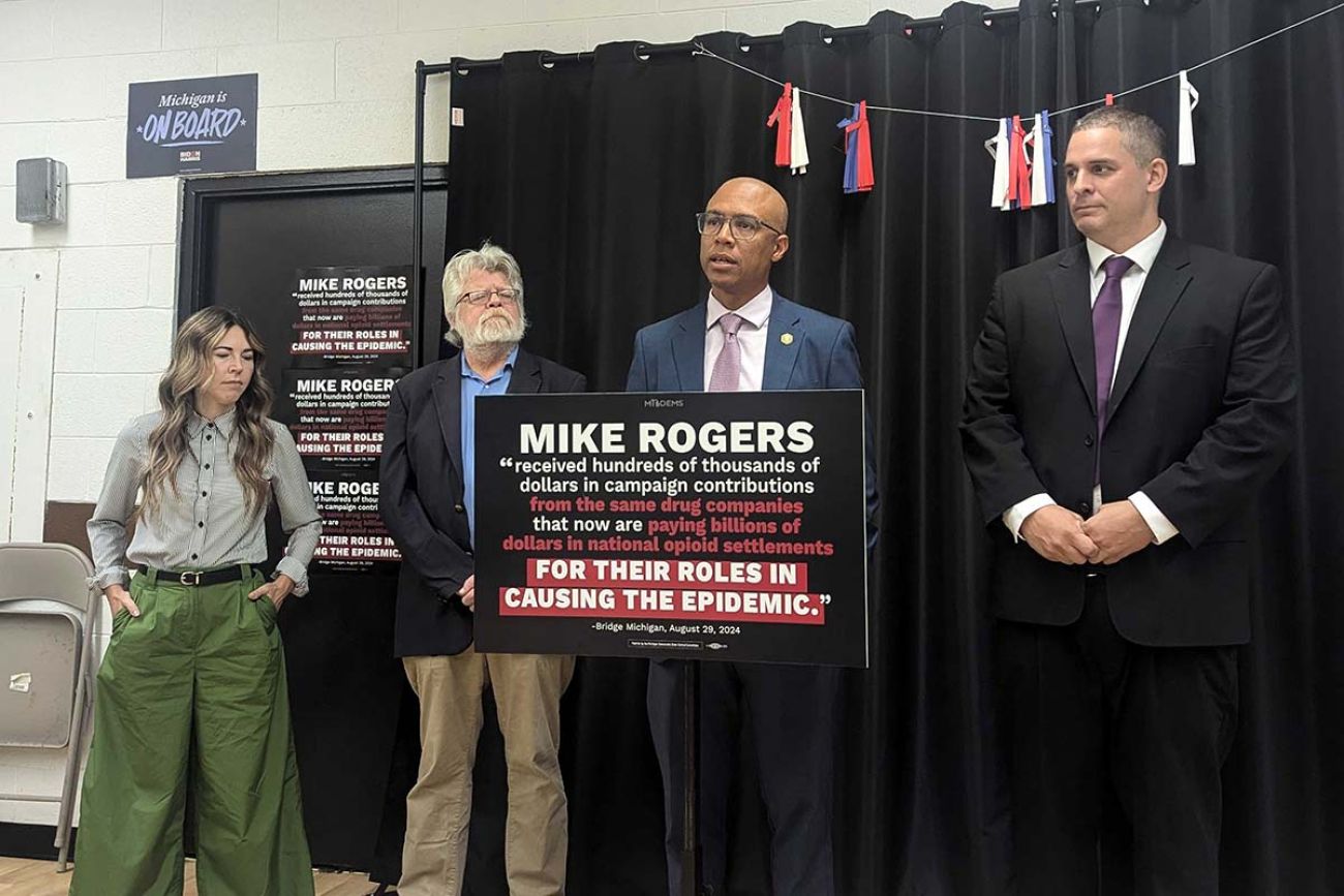 People are stand up behind a podium for a press conference 