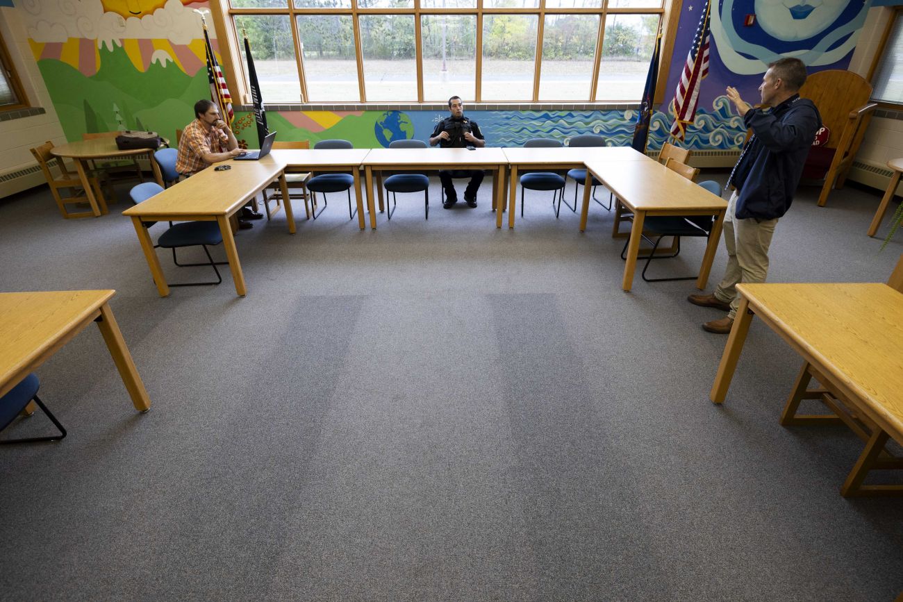 Three people around a u-shaped table at the library