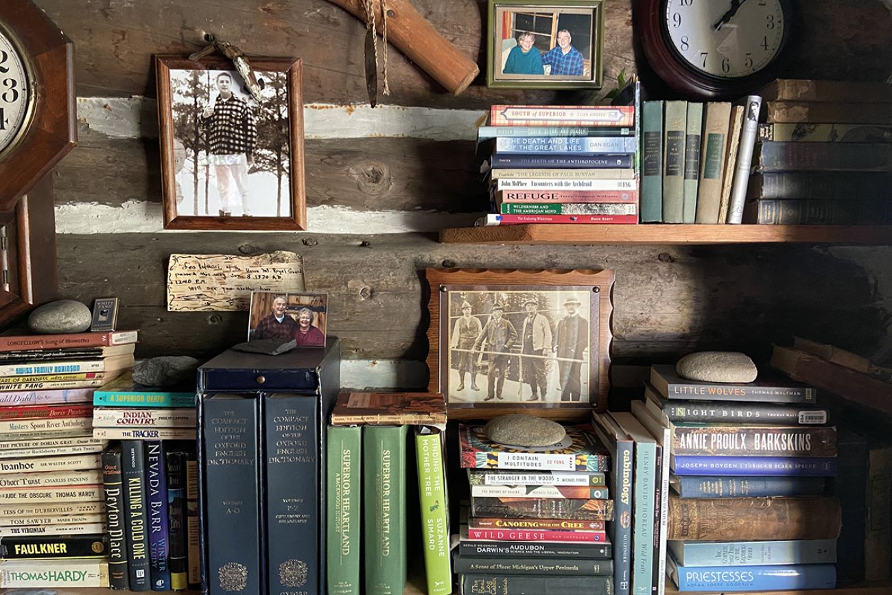 A couple of different book shelves. There are also some family pictures on the wall