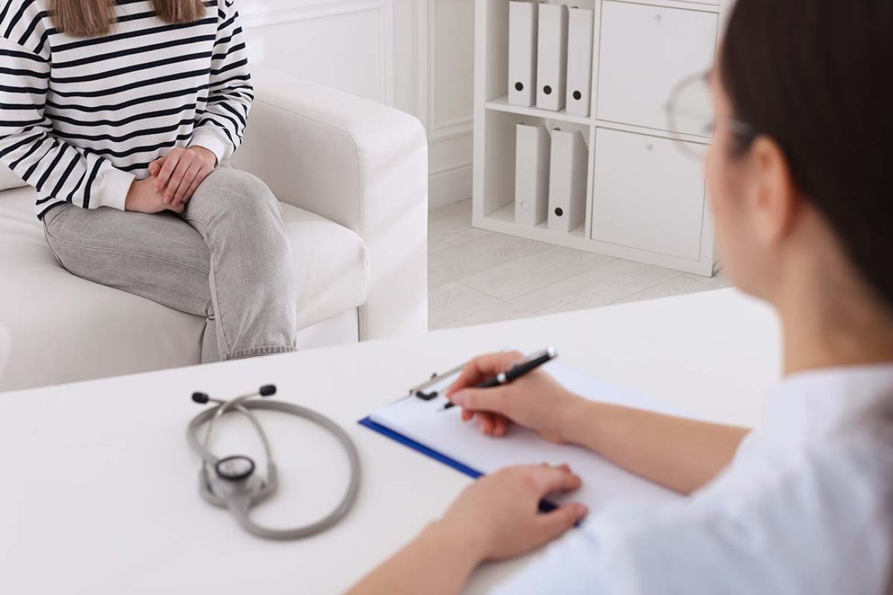 Young woman having appointment with STD specialist in clinic