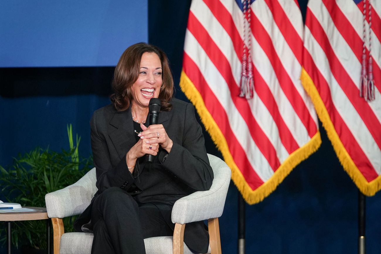 Vice President Kamala Harris speaking into a microphone