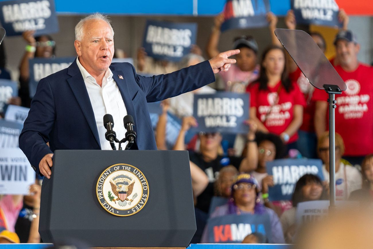 Tim Walz on stage at a rally in Michigan