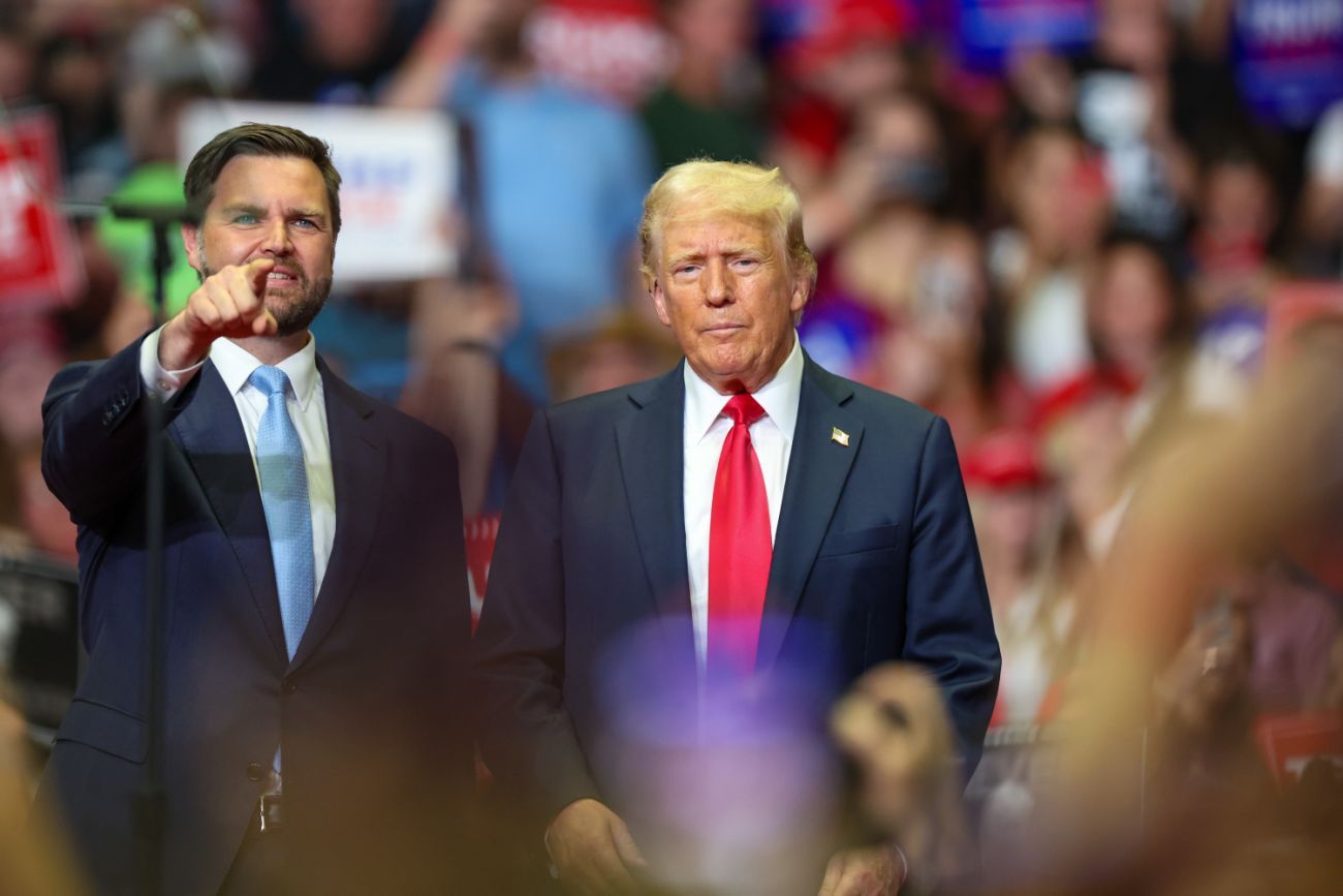 JD Vance and Donald Trump stand next to each other at a rally in Michigan