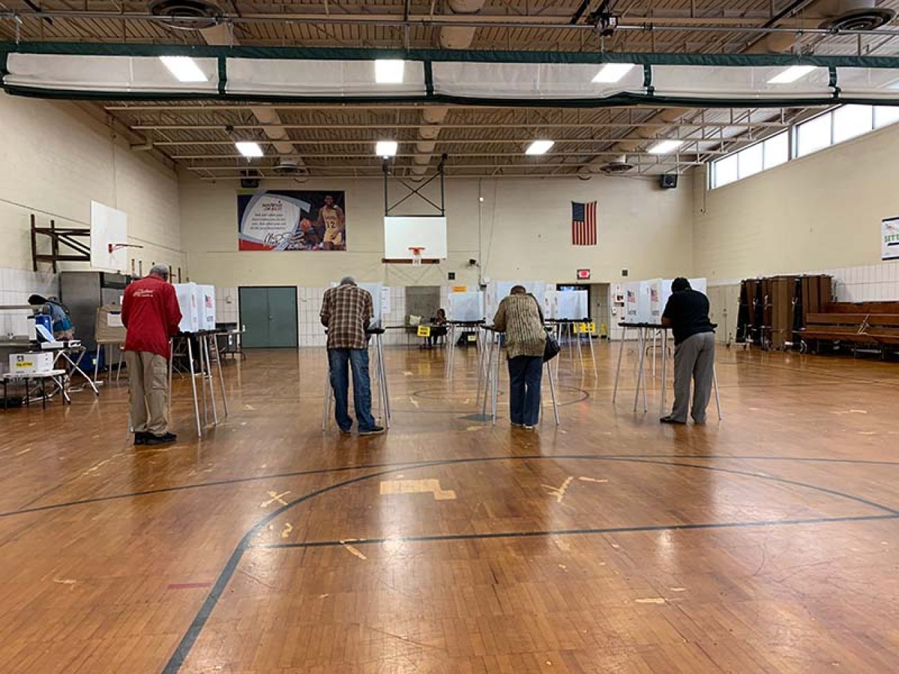 People in a school gym, voting