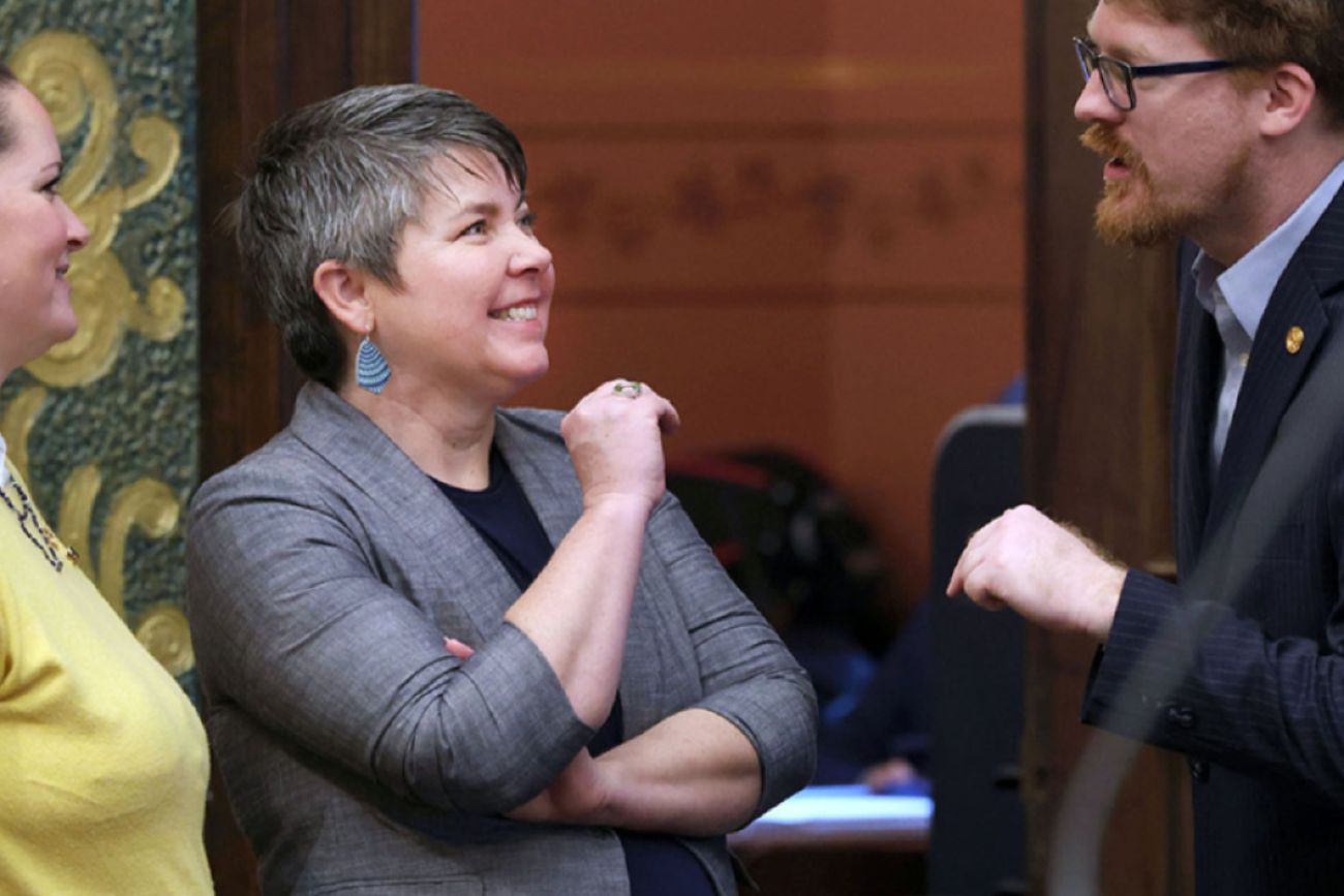 Woman smiles at a man talking to her