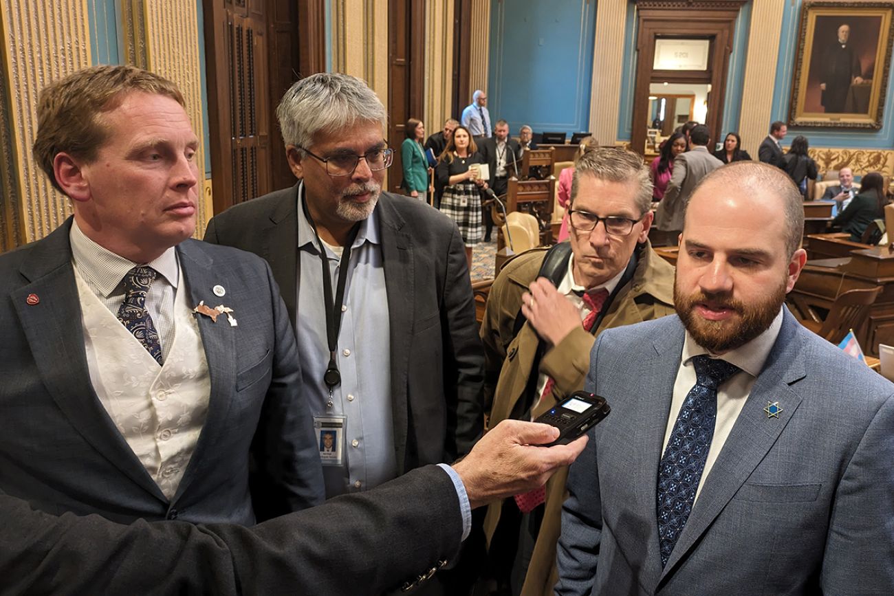 State Sens. Ed McBroom, left, and Jeremy Moss on the Michigan Senate floor. They are standing next to each other