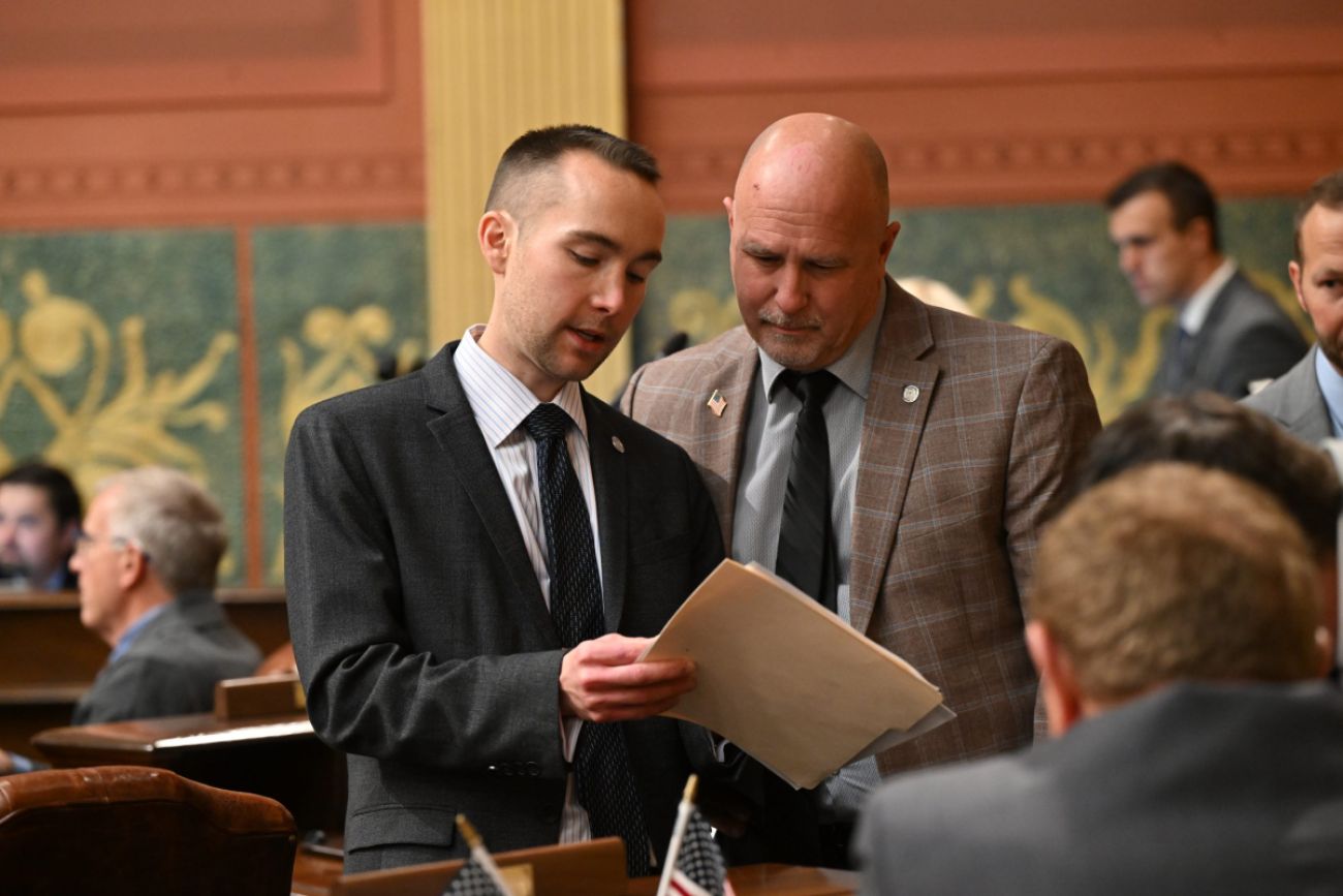 Two men stand in Michigan House chambers