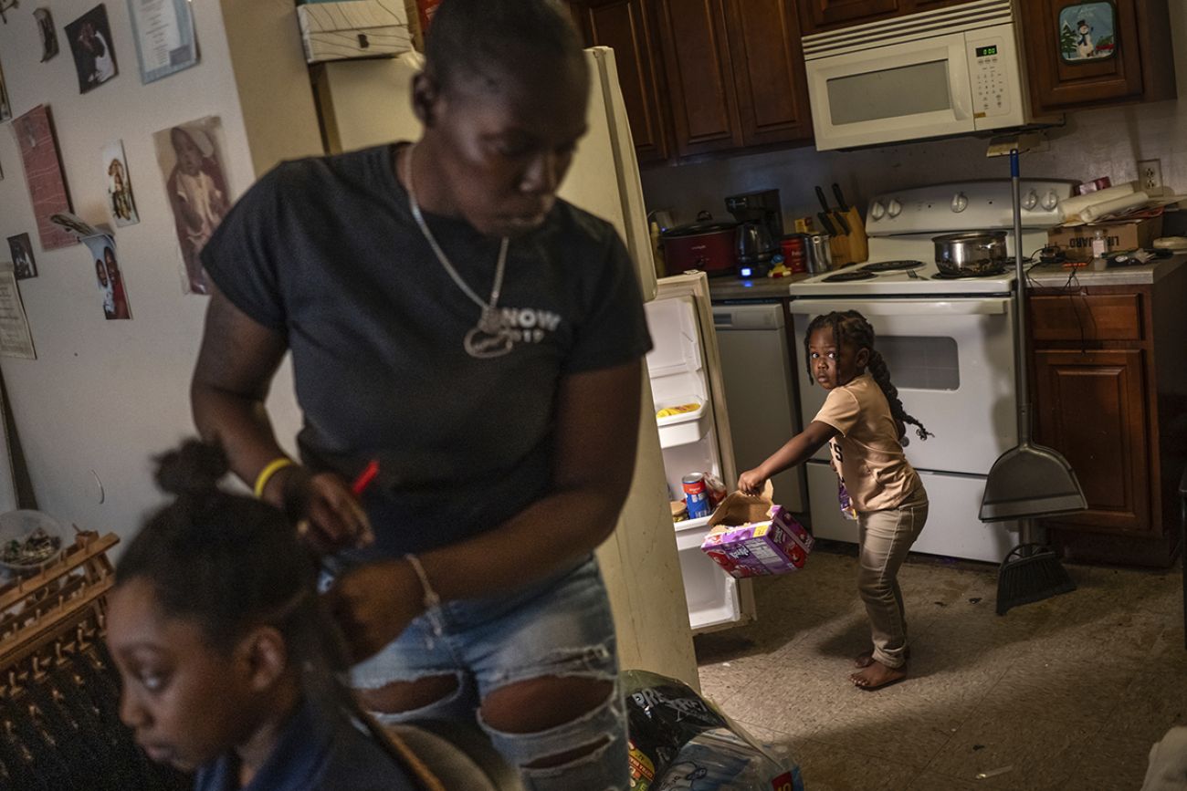 A mom and her daughters in the kitchen 