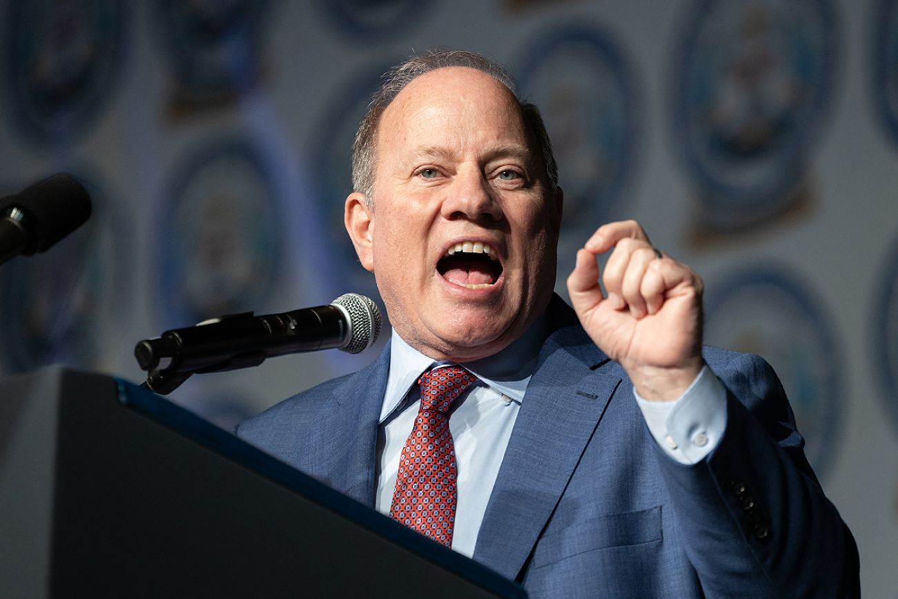 Detroit Mayor Mike Duggan speaking into a microphone