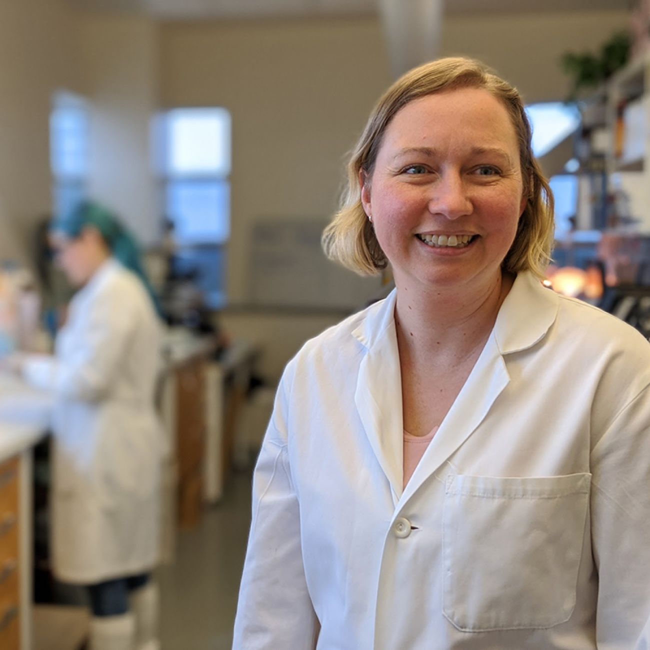 Emily Toth Martin in a white lab coat