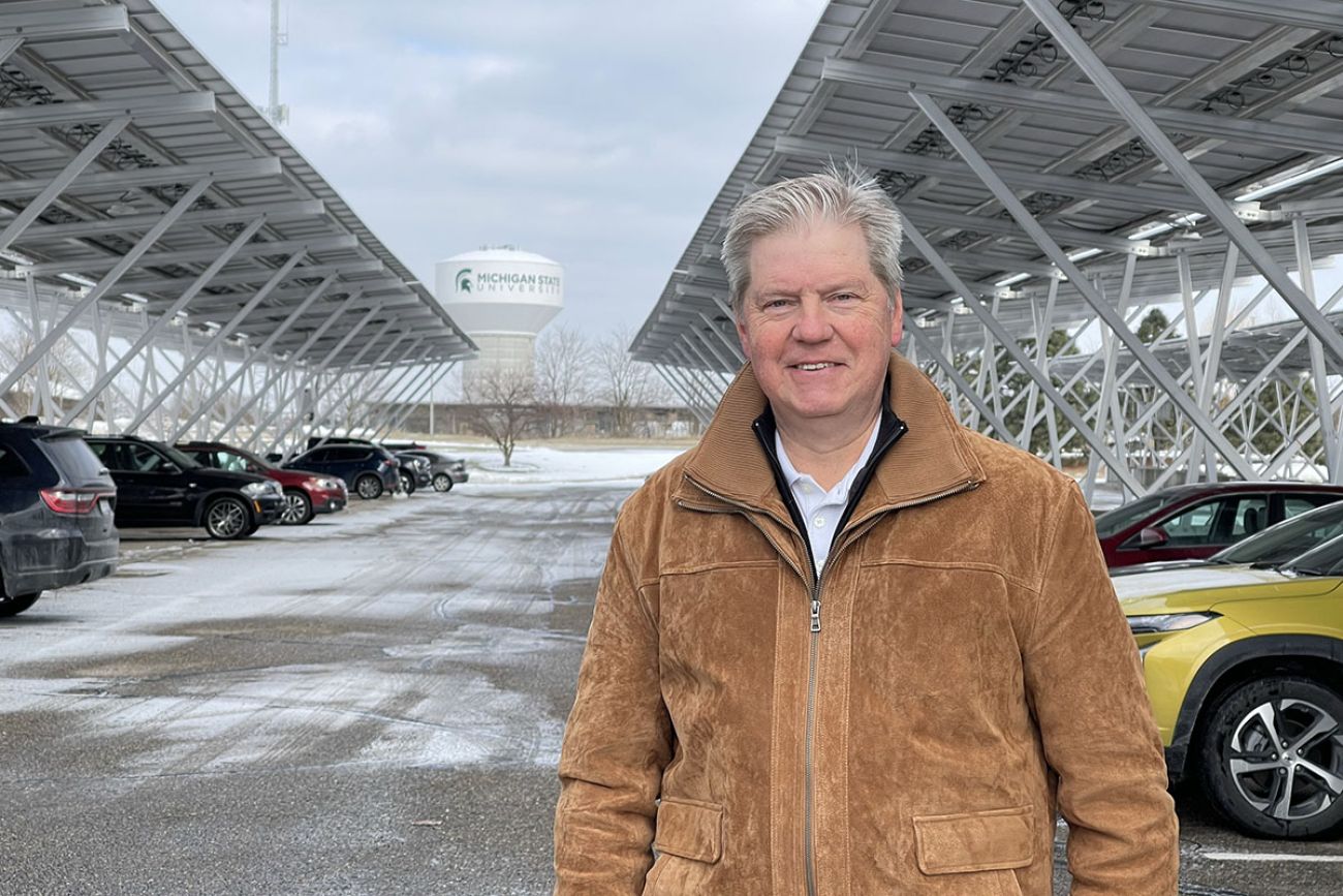 Wolfgang Bauer poses for a picture in a solar-powered carport. 