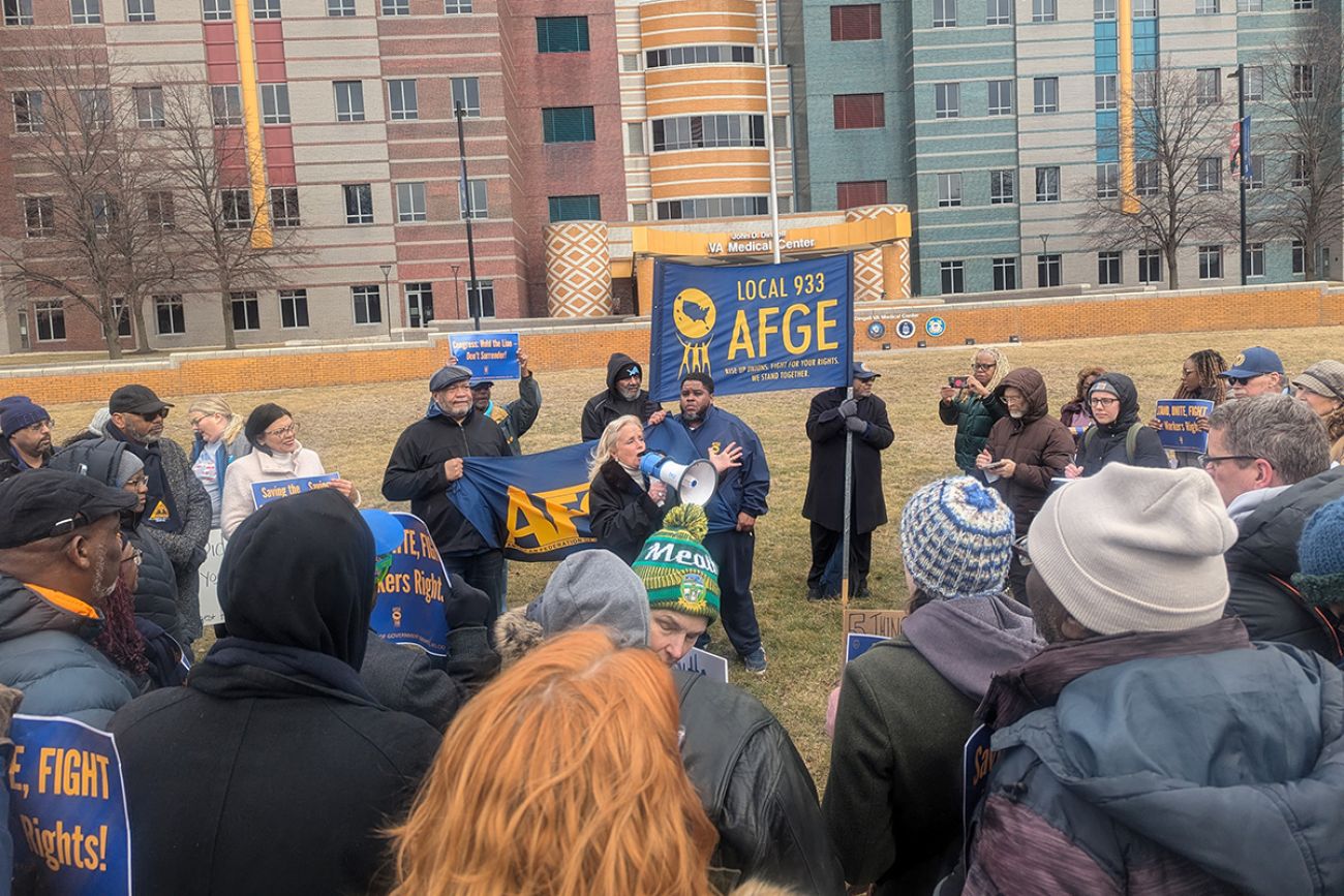 US Rep. Debbie Dingell, D-Dearborn, speaking into a megaphone in a crowd.