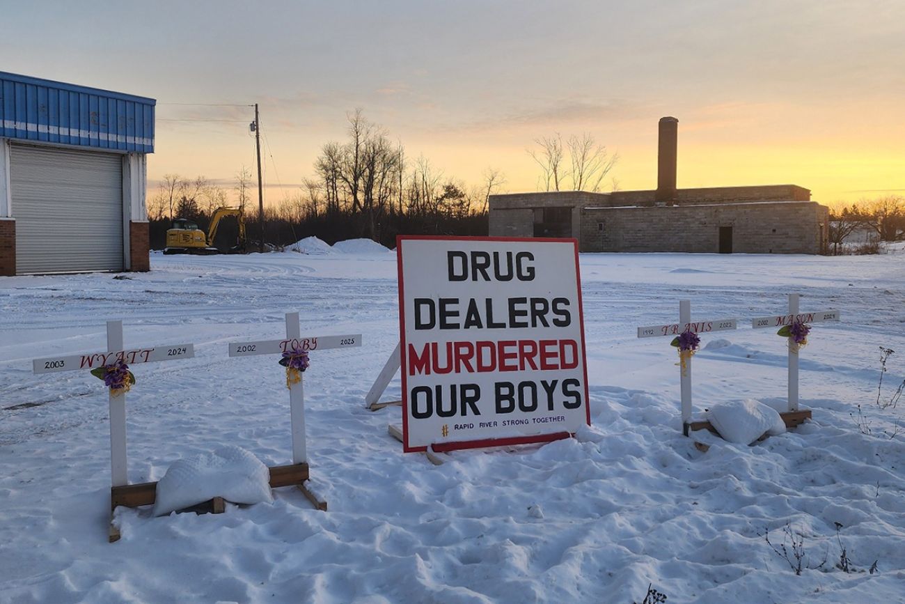 A sign that says "Drug Dealers Murder Our Boys."