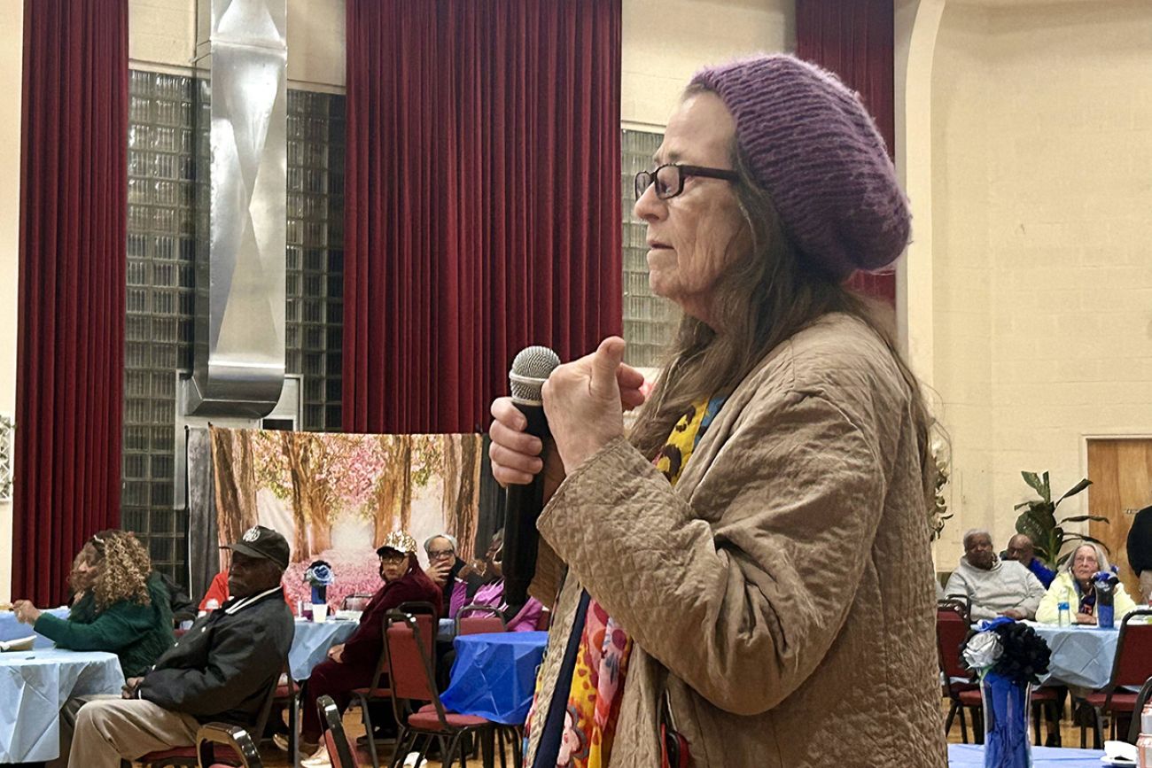 Flint resident Carroll Kinkade speaks about the microphone.