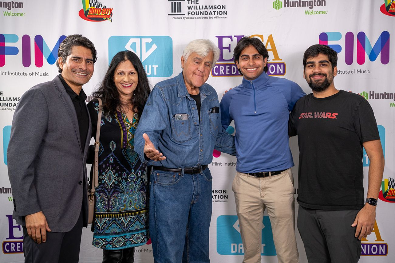 Dr. Bobby Mukkamala poses in a group photo with Jay Leno.