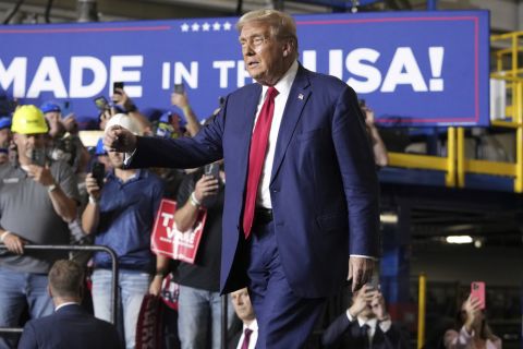 Republican presidential nominee former President Donald Trump walks on to the stage in Walker, Mich