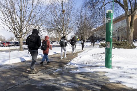 Students walking on a college campus. 