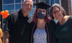 Tim Fournier, left, and Ingrid Fournier, right, stand with their daughter. 