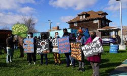 people outside with signs