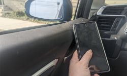someone holding phone in car