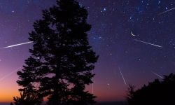Starry Milky Way skies with comet and meteor shower, falling and shooting stars.