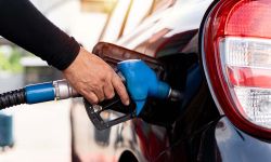 driver hand refilling and pumping gasoline oil the car with fuel at he refuel station. 