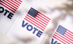 white vote signs that features an American flag