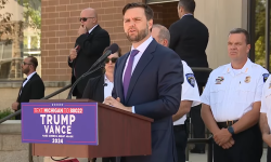  JD Vance standing at a podium outside of the Shelby Township Police Departmen