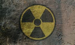 Radiation hazard warning sign depicted on a concrete wall