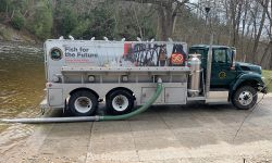 A Michigan DNR specialty stocking truck, which has a hose that goes down to the river