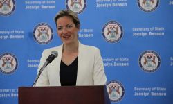 Michigan Secretary of State Jocelyn Benson speaking into a microphone