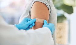 vaccine and doctor hands with plaster on patient arm in a medical hospital or clinic. 