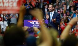 J.D. Vance clapping his hands on stage at a rally