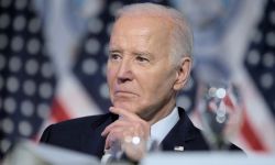 Joe Biden with American flags behind him