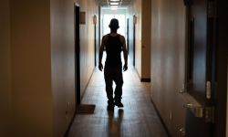 A man walking down a hallway at the Andy’s Place recovery housing in Jackson